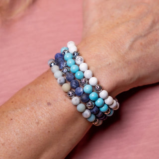 Man Wearing Gemstone Bracelet Stack.