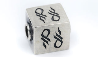 Alt= Logo cube charm piece.