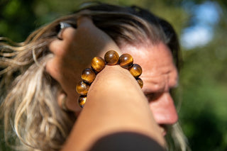 Alt= Male wearing tigers eye beads