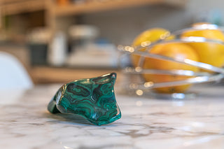 Malachite Gemstone Geode sitting on kitchen table.