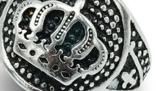 silver decorated cross ring close up