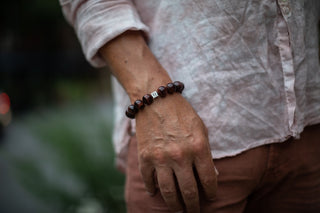 Alt= Male model wearing redtigers eye 14mmm sterling silver cube bracelet.