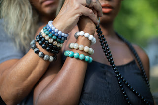 </"Caucasian-male-model-sitting-casually-wearing-natural-stone-accessories"/>
