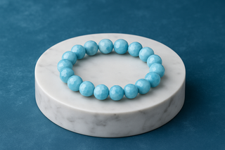 Larimar gemstone bracelet on marble podium
