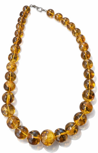 Necklace with amber-colored beads on a white background
