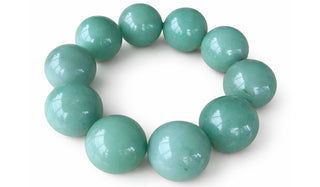 Green aventrine gemstone bracelest on a white background