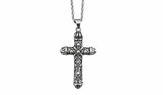Silver cross pendant necklace on a white background