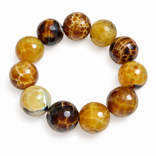 A beaded stretch bracelet made of faceted round beads in shades of golden yellow, amber, and dark brown with natural marbled patterns, shown on a plain white background.