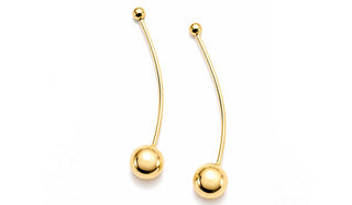 A pair of curved gold-tone labret earrings with smooth spherical ball ends, displayed on a clean white background.