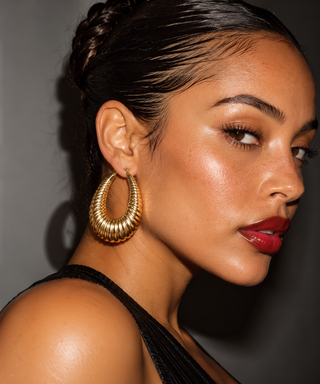 model wearing gold ribbed earrings