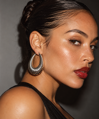model wearing silver ribbed earrings