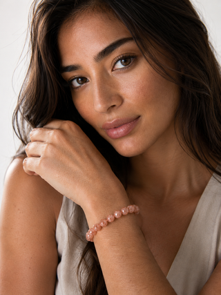 women wearing peach moonstone gemstone bracelet
