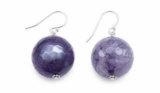 A pair of silver fishhook drop earrings featuring faceted, hammered purple stone beads, shown against a plain white background.