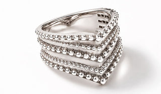 Silver ring with multiple bands on a white background