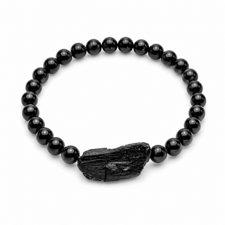 A black beaded bracelet featuring round glossy beads and a textured, irregular black stone centerpiece, displayed on a clean white background.