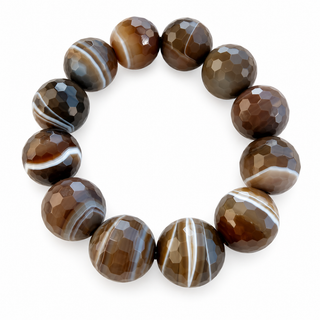 A circular beaded bracelet made of faceted brown agate beads with natural white and gray banding, displayed on a clean white background.
