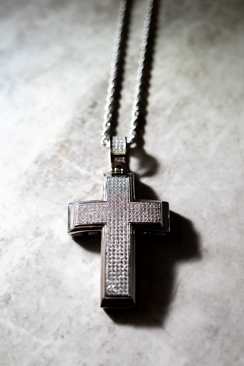 The Big Boss Cross Necklace on tile