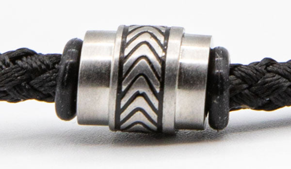 Stainless Steel Charm on black cord bracelet.