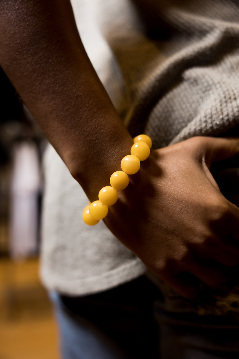 Woman wearing yellow calcite gemstone bracelet.