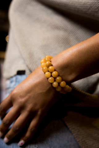 Woman wearing Yellow Jade Bracelet.