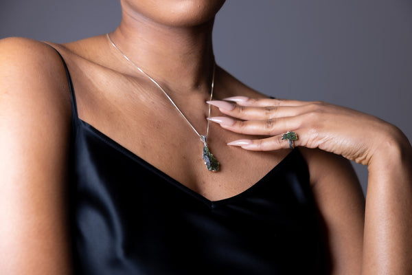 woman wearing Sterling Silver Long Triangle Moldavite Necklace