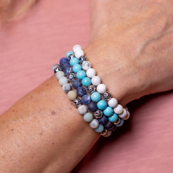 Man Wearing Gemstone Bracelet Stack.