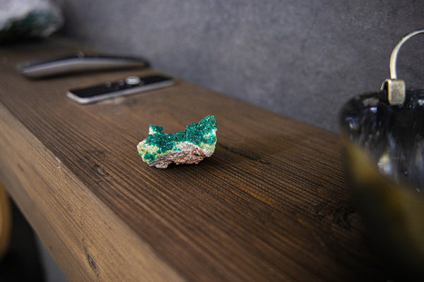 Dioptase Cluster sitting on TV stand.