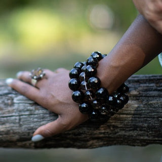 Alt= Female wearing faceted smoky quartz bracelets.
